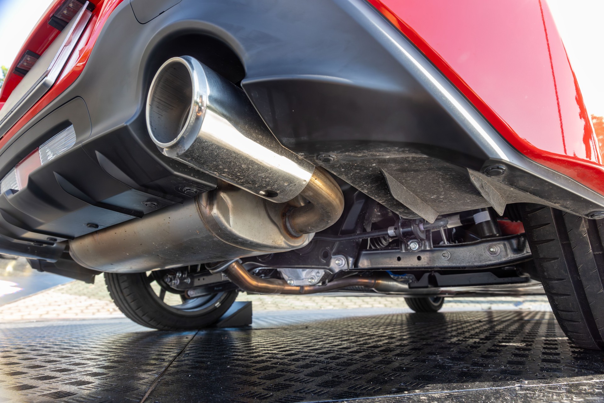 Rear car exhaust pipe and suspension.
