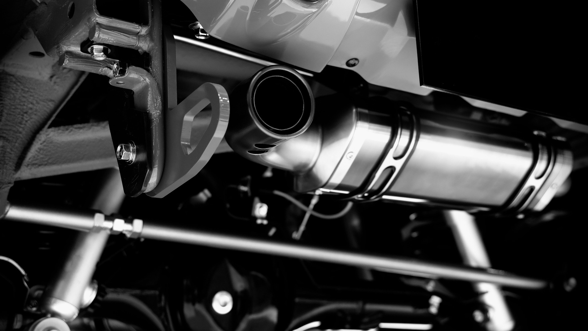 Car suspension part. Close up of a rear car suspension and exhaust system. such as coil springs link arms axle housing and performance exhaust. For auto engineering or car suspension part industry use